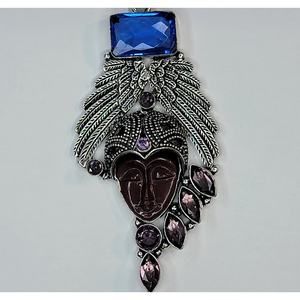 Sterling Silver Pendant with Brown Carved Face, Blue Topaz, and Feather Motif